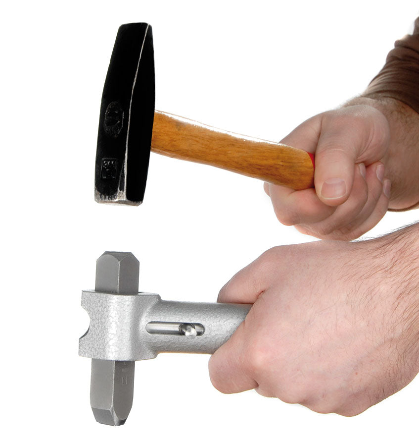 HHS metal hand stamp holder with spring lock, shown holding a punch during use; hammer and punch shown for demonstration