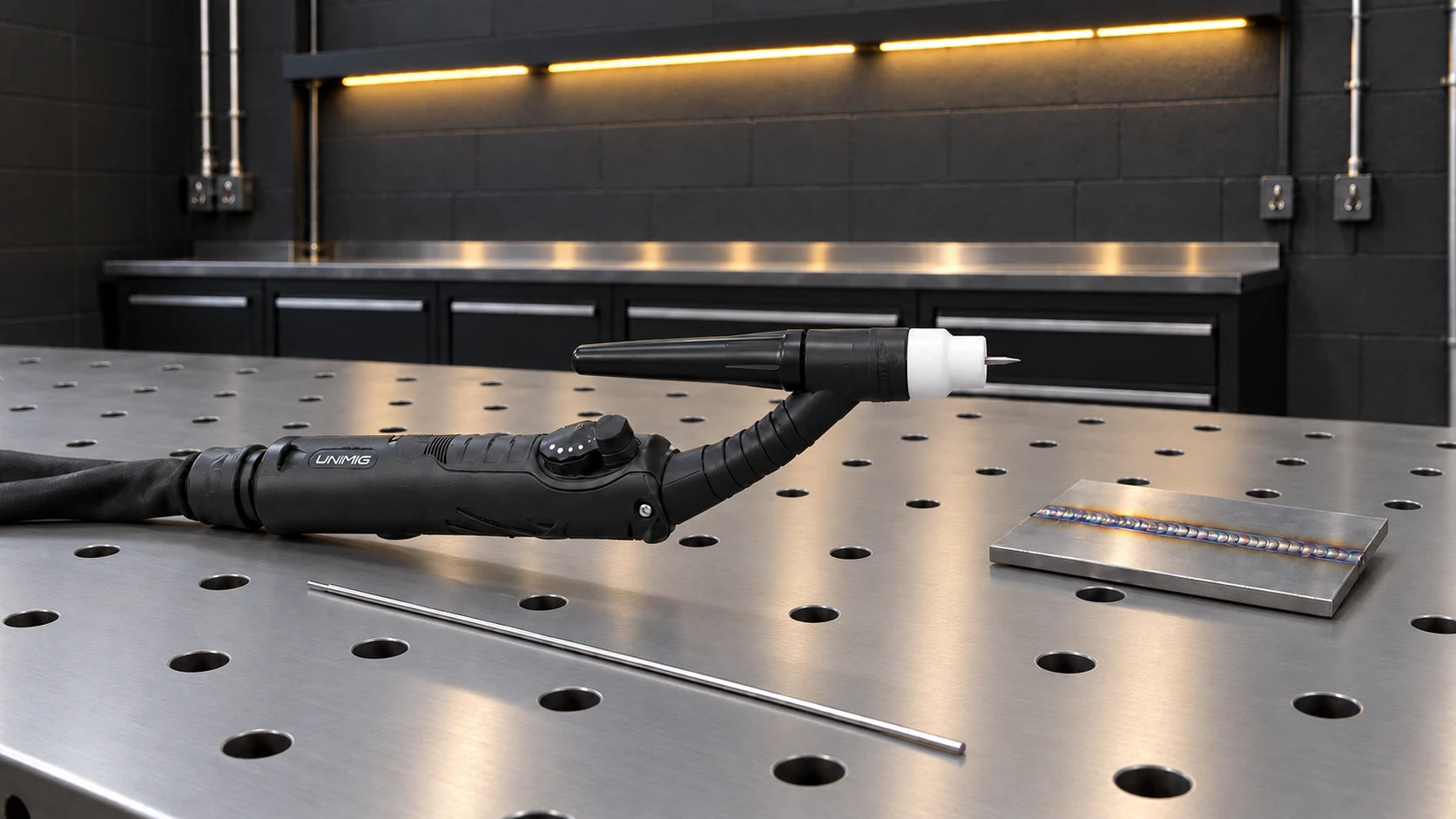TIG torch and its cup on a workshop bench